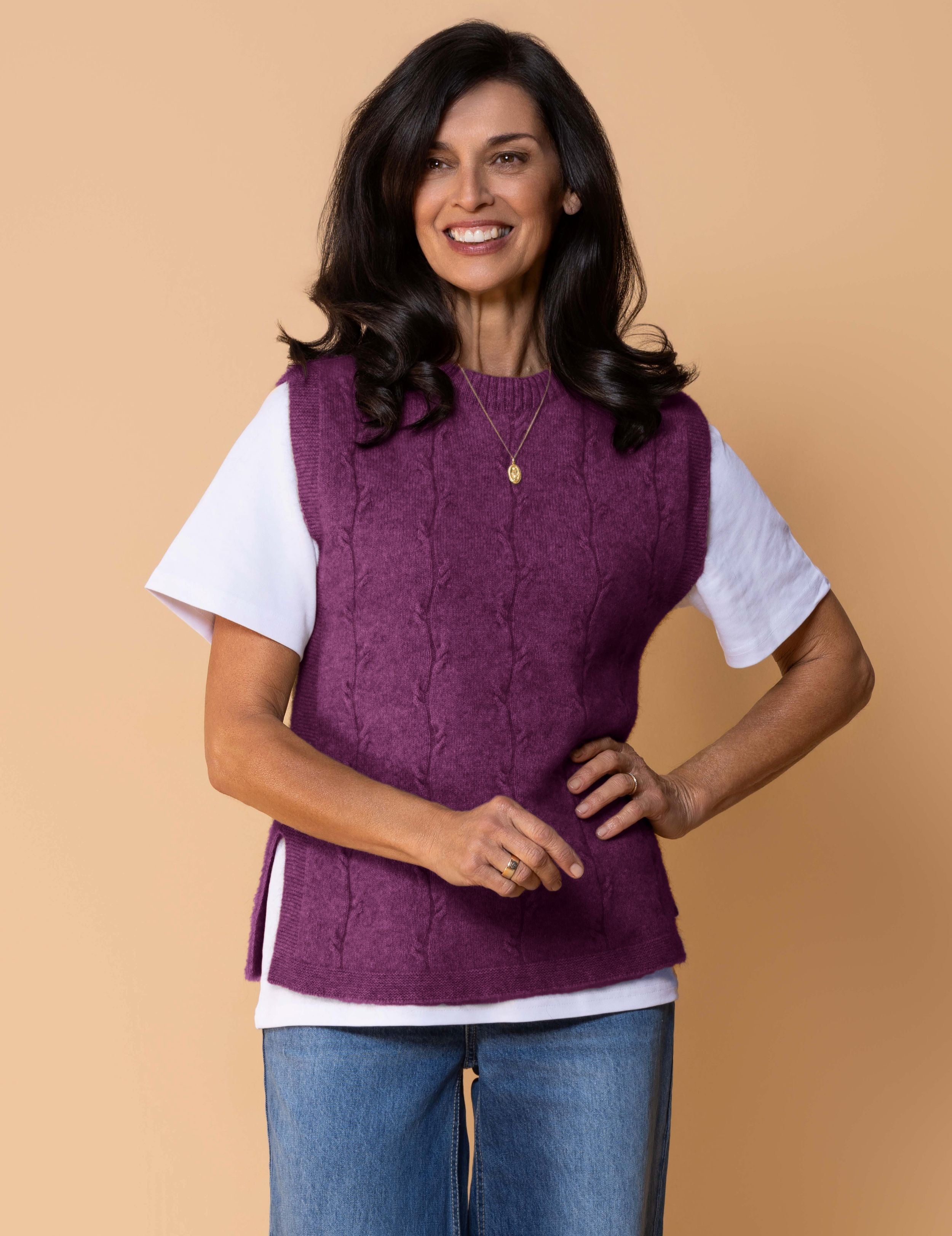 Sleeveless knit vest in soft possum merino blend with minimalist silhouette, cable detailing, side splits.