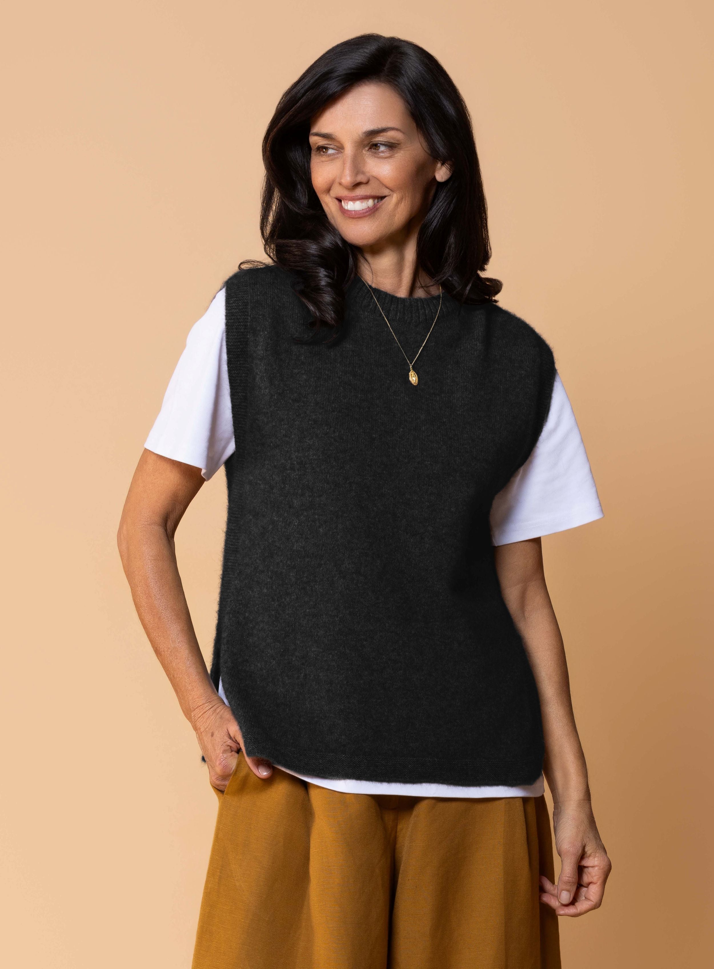 Women's Kowhai Vest in Black, soft possum merino knit sleeveless vest with round neckline, side splits and relaxed fit for layering.