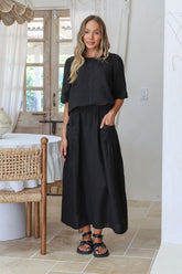 Black linen skirt with flowing silhouette and soft breathable drape