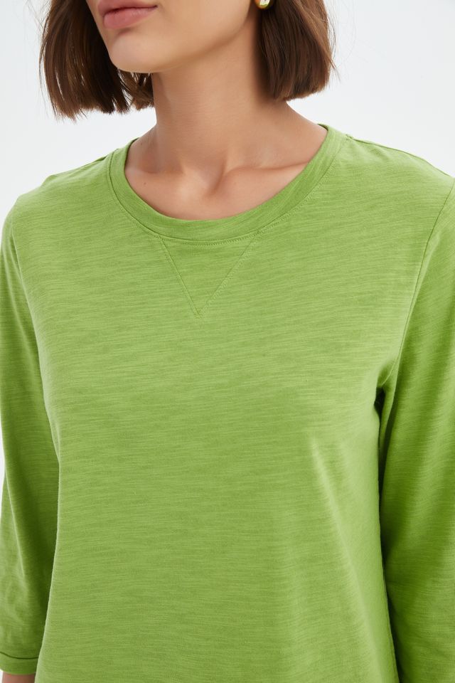 Fern Green cotton slub tee featuring a round neckline with V-insert detail, 3/4 sleeves, relaxed fit, and curved hem.