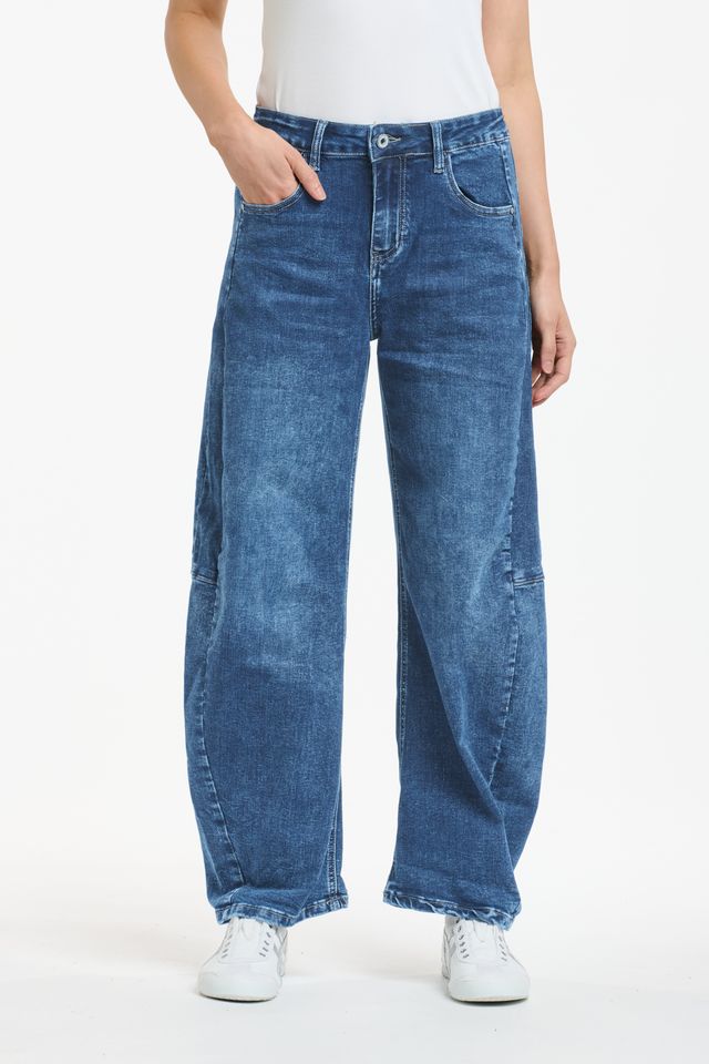 Blue denim barrel leg jeans with curved silhouette and tapered ankle
