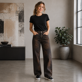 Vera May Italian denim jeans in a black denim wash with subtle leopard print and diamanté embellishments on the front, featuring a high-rise waist and full-length wide-leg silhouette.