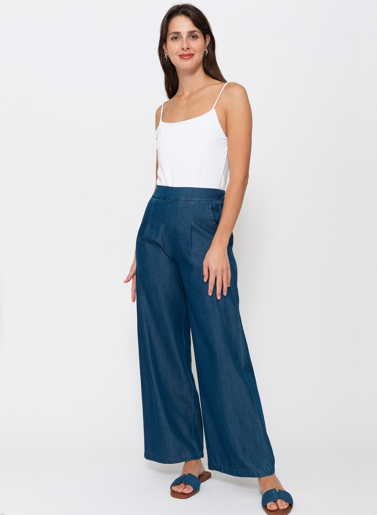 Dark denim palazzo pants in cotton–lyocell blend with basque front waist, elastic back, front pleats and side pockets. See the Blueberry Italia range at Linens & Treasures now