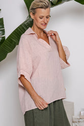Blush linen top with V-neckline, raglan sleeves, and soft gathered cuffs — relaxed fit from Linens & Treasures