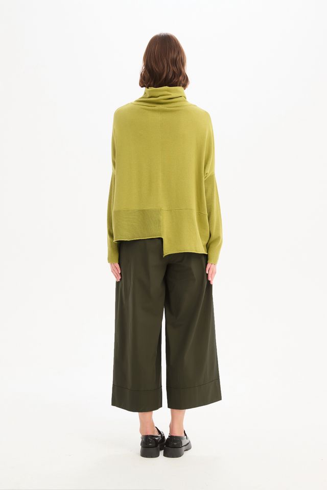 Tirelli Roll Hem Pocket Knit in Deep Citrus featuring a relaxed oversized fit, rolled cowl neckline, ribbed sleeves, front patch pocket, exposed centre seam, and asymmetrical roll hem in a vibrant citrus green knit.