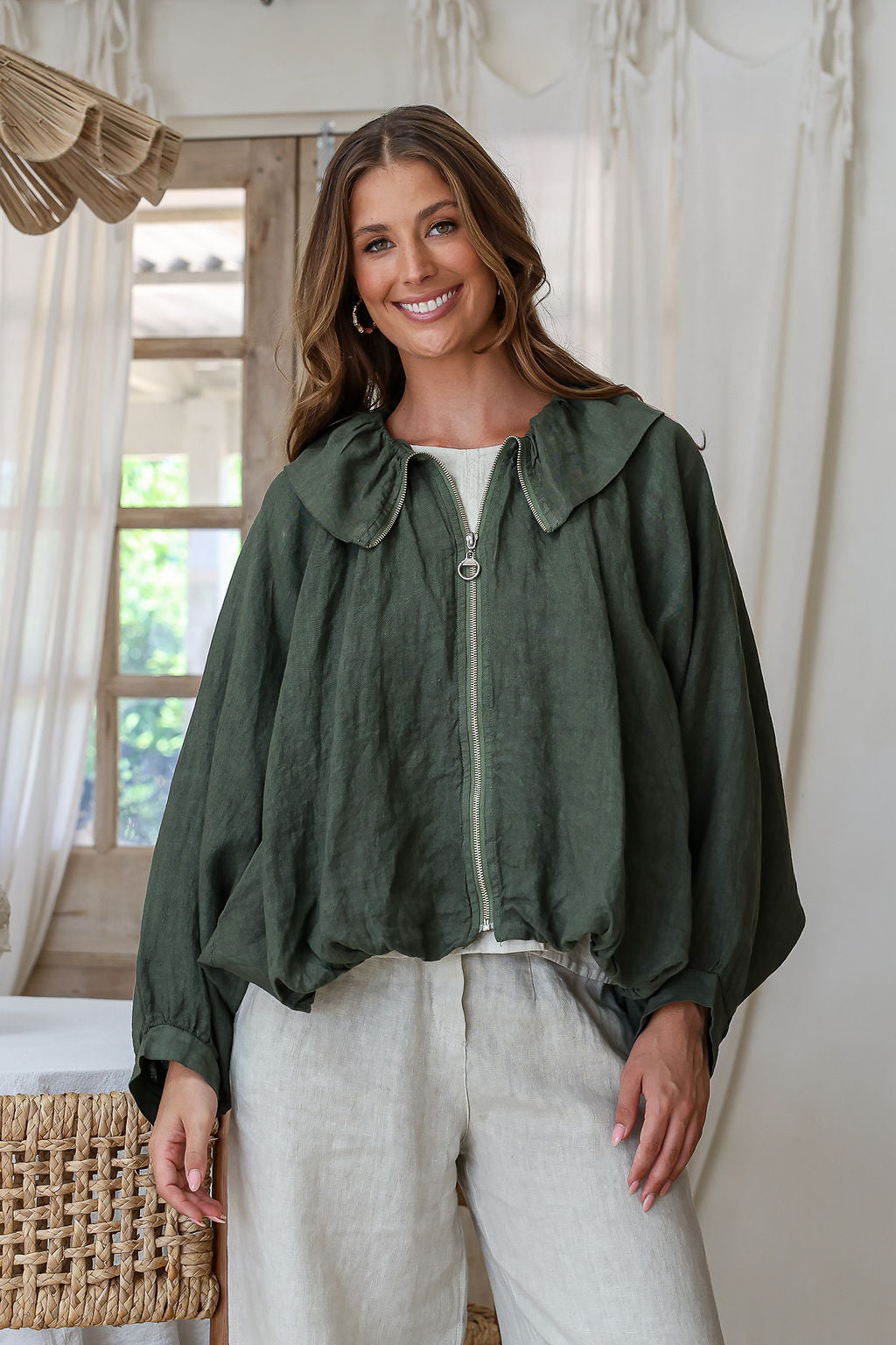 Juniper green linen bomber jacket with cape sleeves, zip front, wide collar and ruched waist