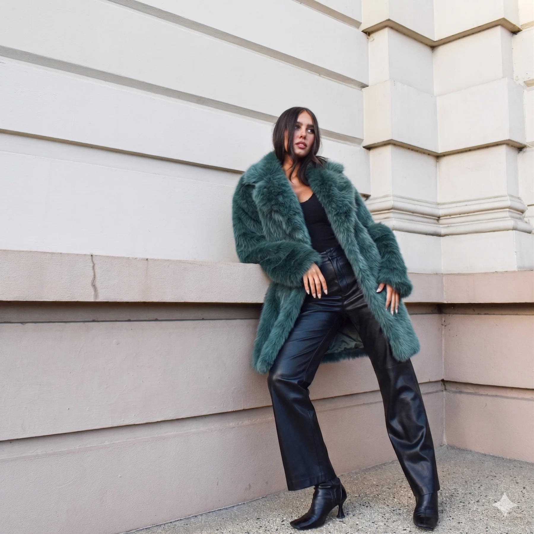 Teal green long faux fur coat with collar and two-button closure, featuring a soft plush texture and elegant longline silhouette.