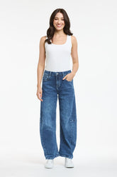 Blue denim barrel leg jeans with curved silhouette and tapered ankle