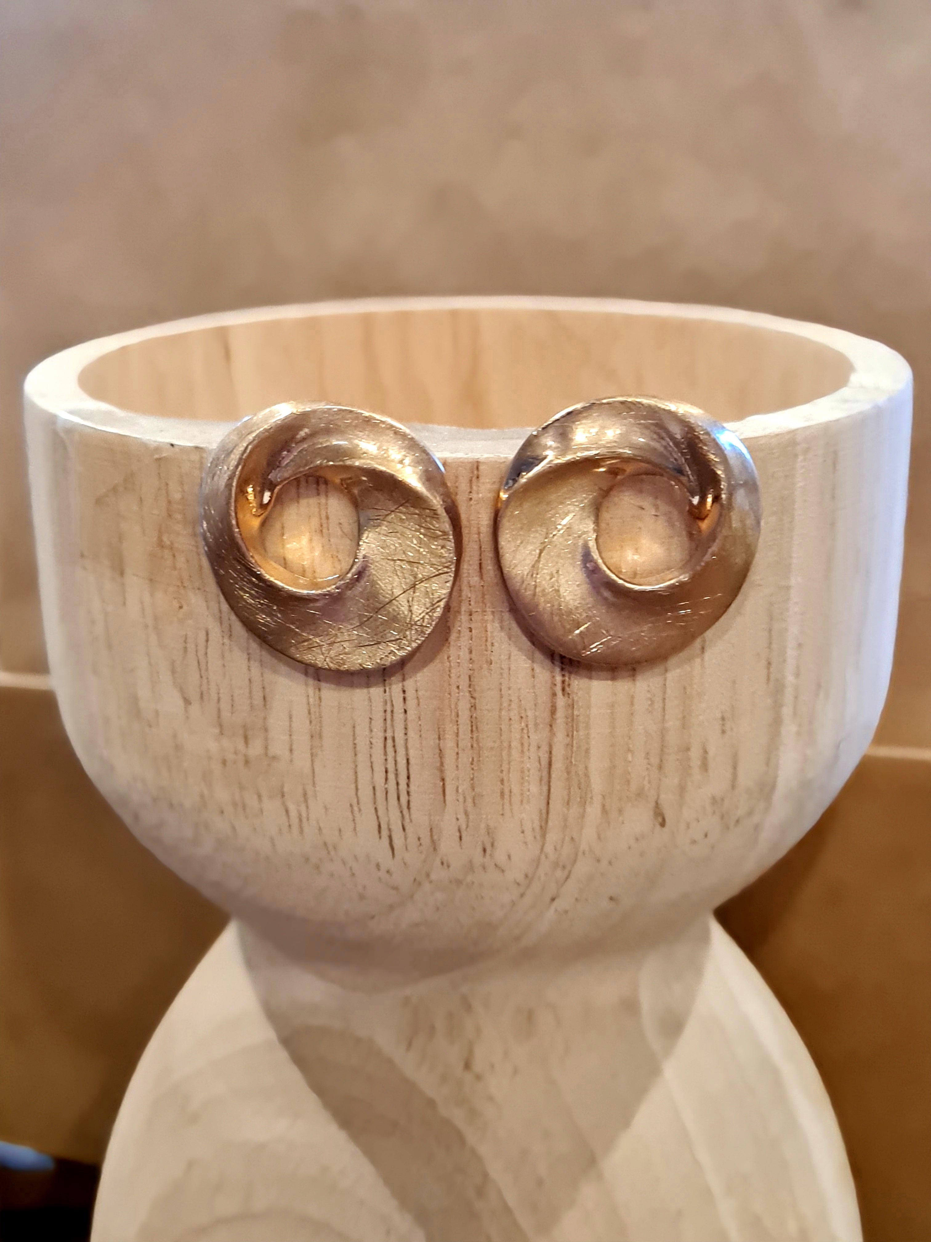 Modern circles in soft gold with a subtle scratched finish. A sleek, understated statement that pairs with everything. Check out Linens & Treasures now