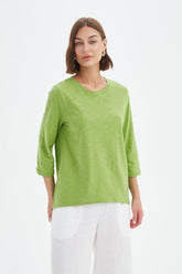 Fern Green cotton slub tee featuring a round neckline with V-insert detail, 3/4 sleeves, relaxed fit, and curved hem.