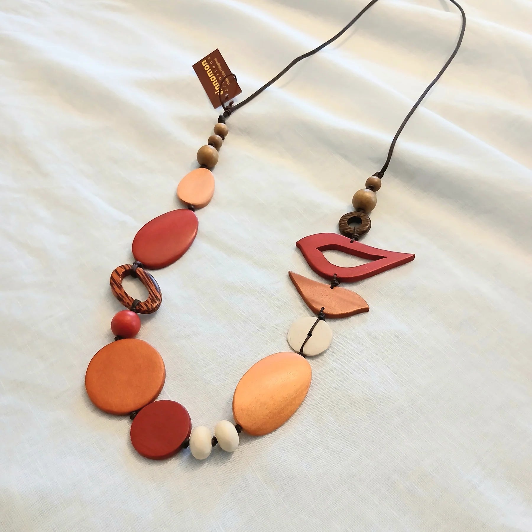 Fabulous range of Wooden Necklaces to add tonal colour to any outfit - see this one in soft rust and light wood tones - Check out the range at Linens & Treasures Rolleston