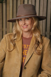 Whiskey toned wool felt wide-brim hat with structured crown and earthy colour contrast.