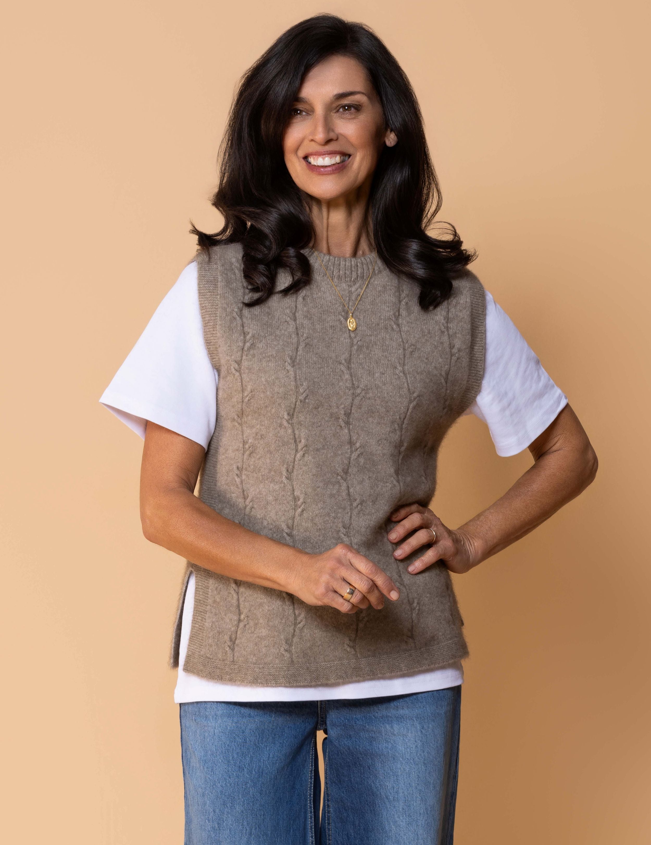 Sleeveless knit vest in soft possum merino blend with minimalist silhouette, cable detailing, side splits.