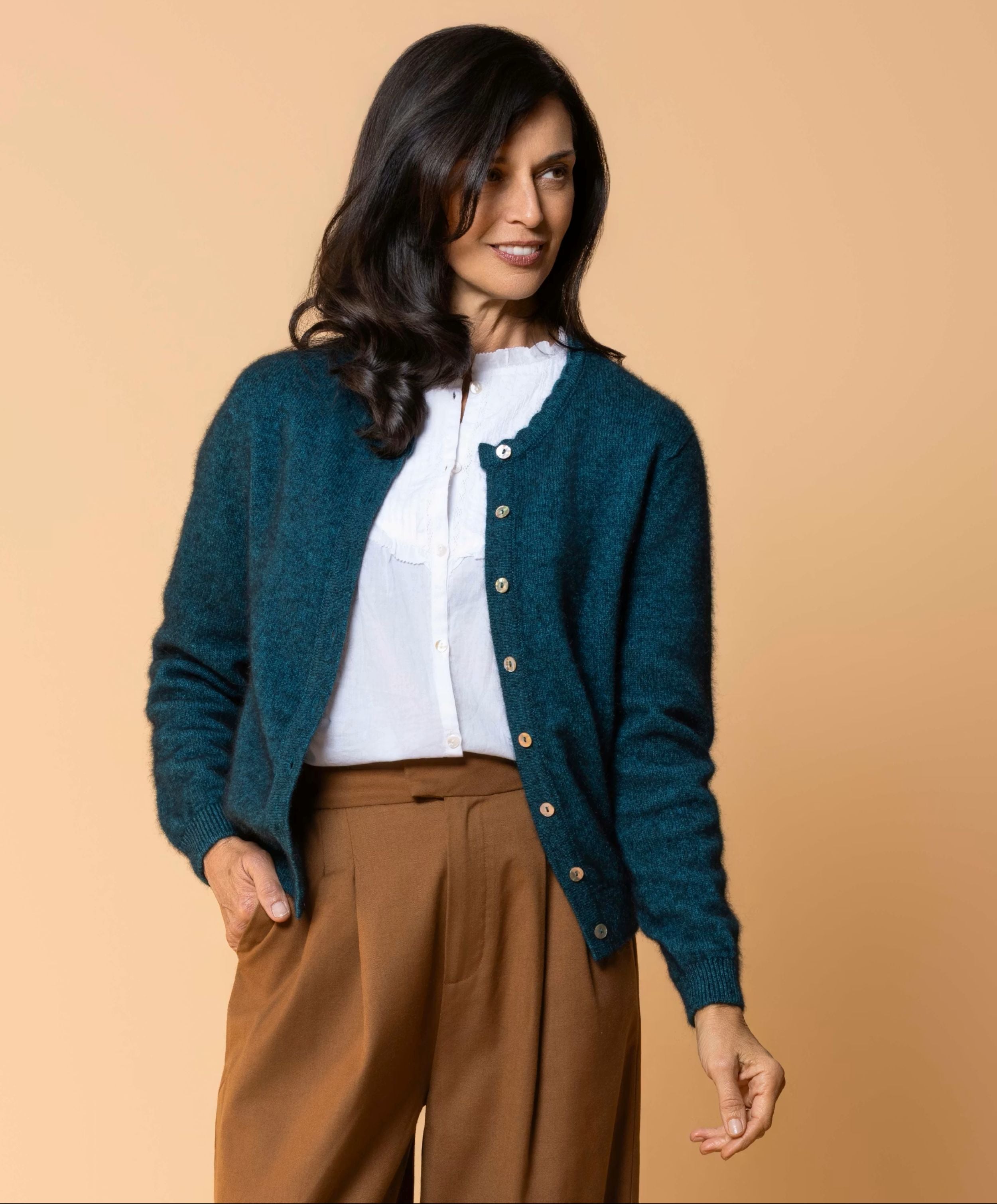 Women's Celeste Cardigan in a luxurious possum merino blend, featuring a feminine scalloped neckline, natural paua shell button front, long sleeves and a classic fit for elegant everyday layering.