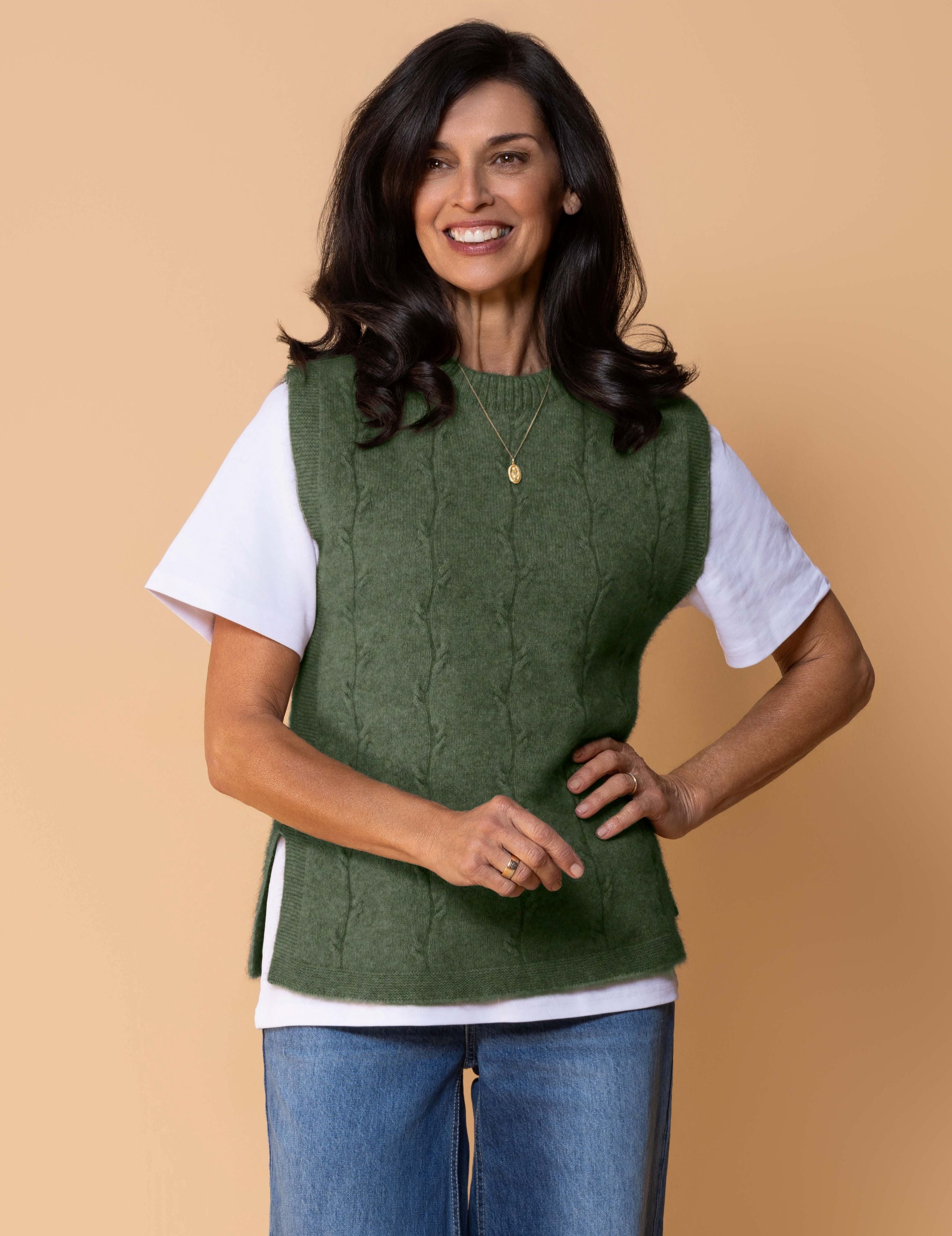 Sleeveless knit vest in soft possum merino blend with minimalist silhouette, cable detailing, side splits.