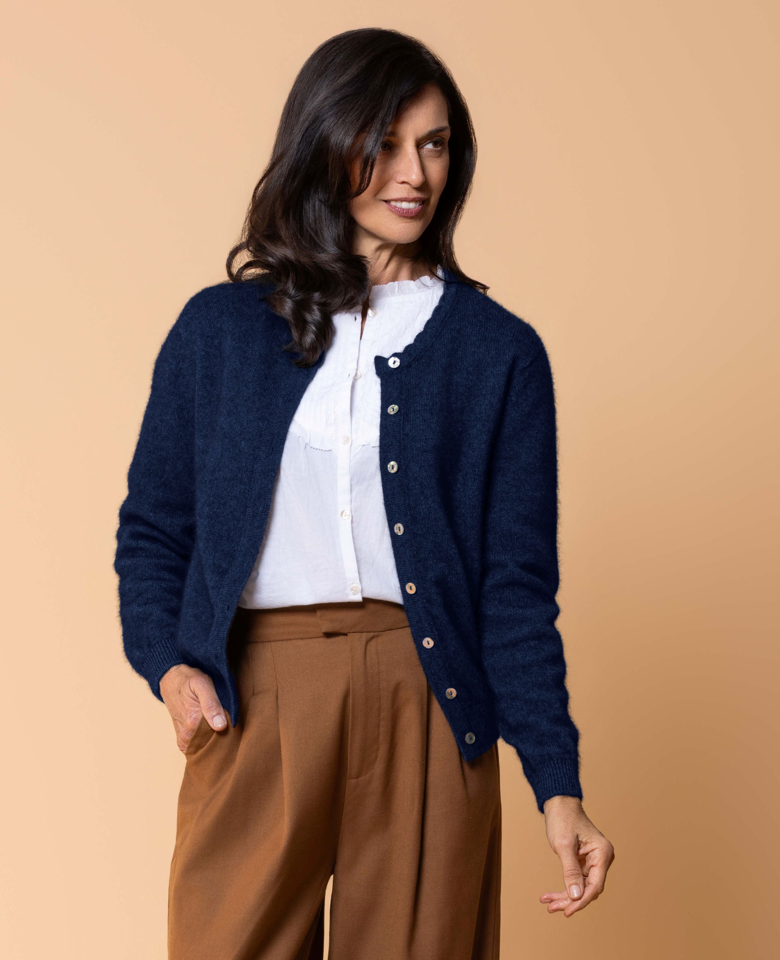 Women's Celeste Cardigan in a luxurious possum merino blend, featuring a feminine scalloped neckline, natural paua shell button front, long sleeves and a classic fit for elegant everyday layering.