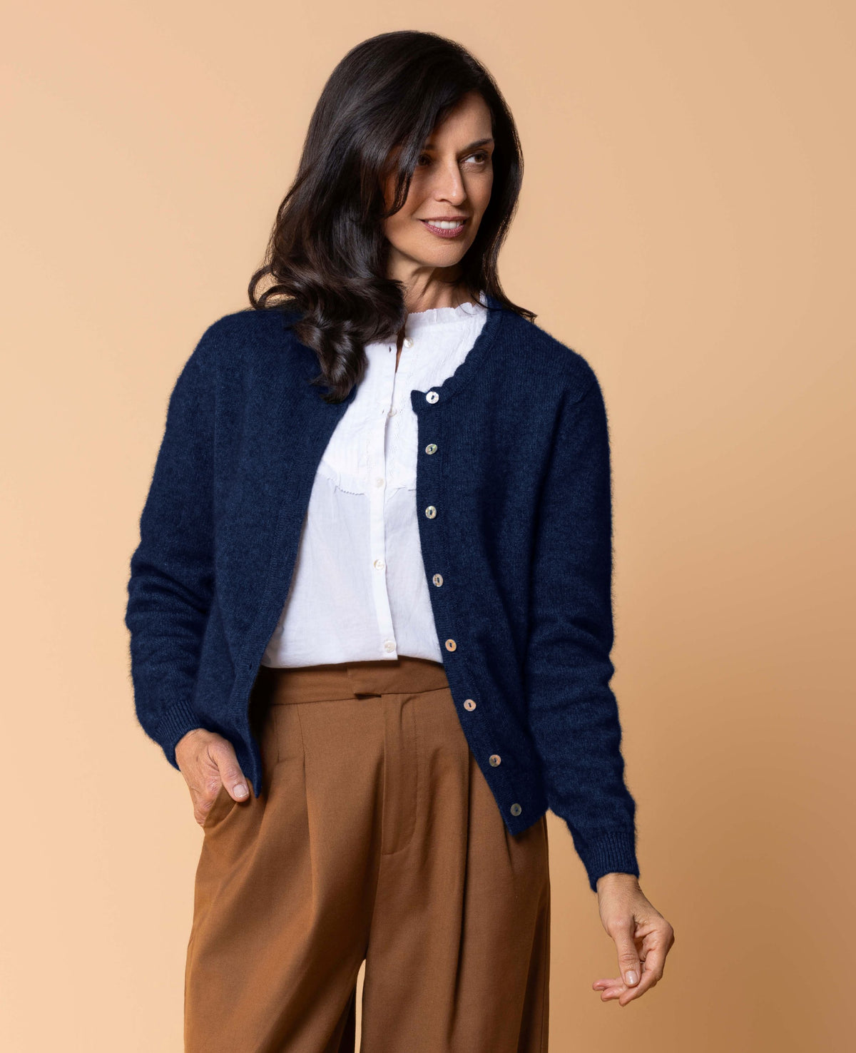 Women's Celeste Cardigan in a luxurious possum merino blend, featuring a feminine scalloped neckline, natural paua shell button front, long sleeves and a classic fit for elegant everyday layering.