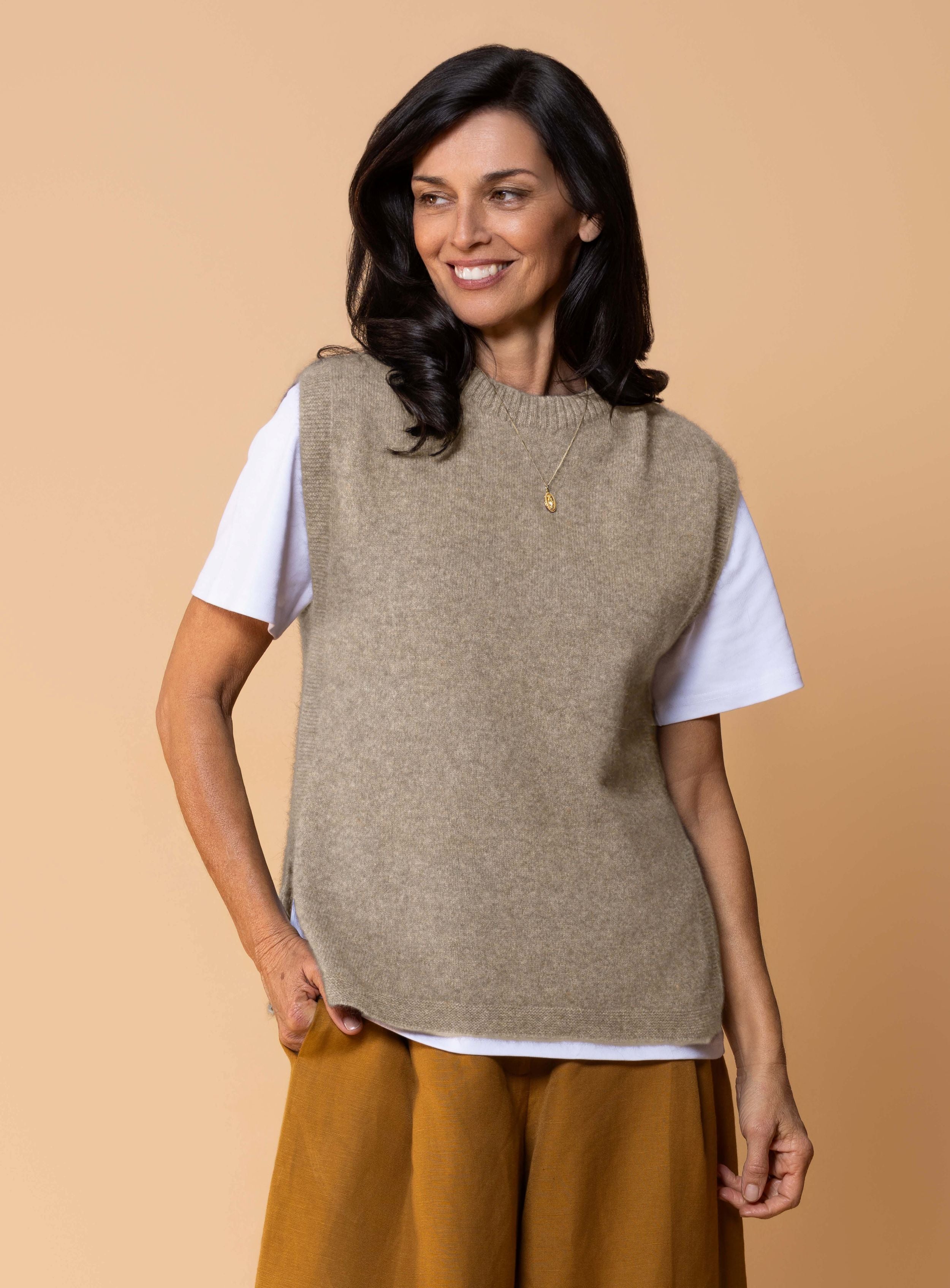Women's Kowhai Vest in Oyster, light neutral possum merino knit sleeveless vest with round neckline, side splits and relaxed fit for layering.