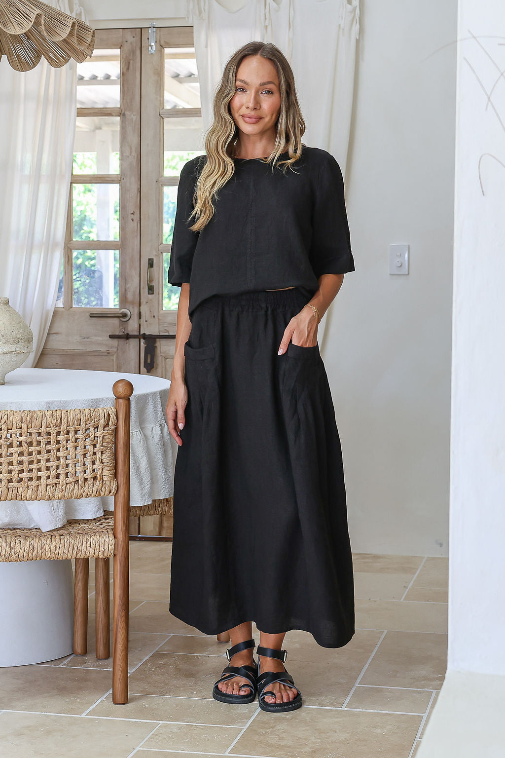 Black linen skirt with flowing silhouette and soft breathable drape