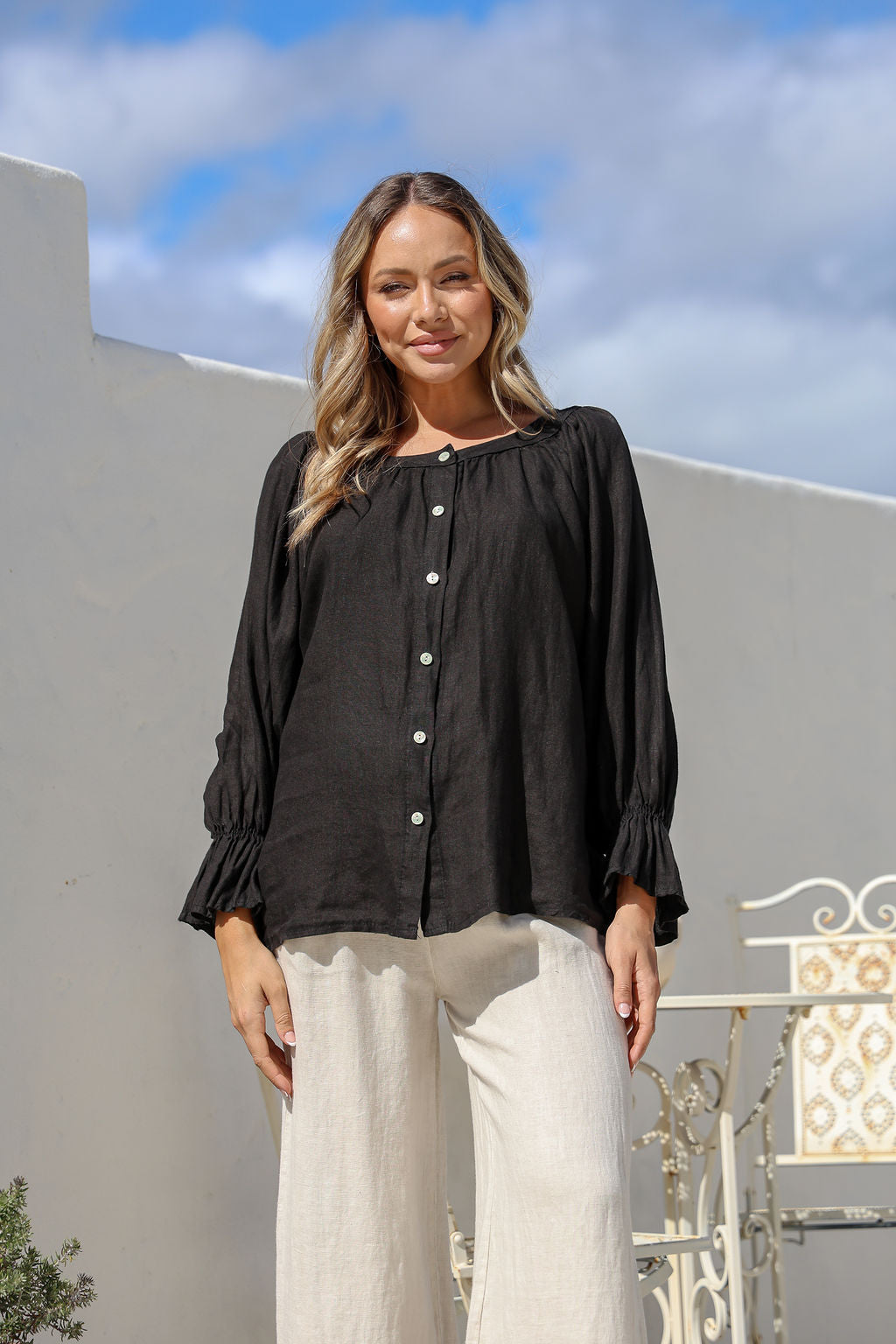 Black linen full-length top with boat neck, button front and cuffed flowy sleeves