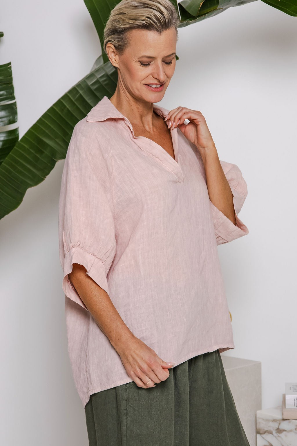 Blush linen top with V-neckline, raglan sleeves, and soft gathered cuffs — relaxed fit from Linens & Treasures
