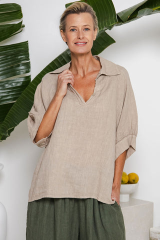 Neutral cashmere-tone linen top with collar, buttoned plaquette, and loose draped silhouette — eco-luxury design from Linens & Treasures