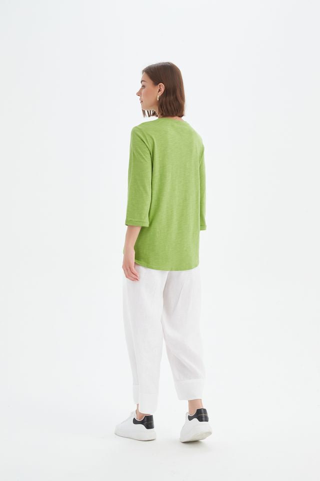 Fern Green cotton slub tee featuring a round neckline with V-insert detail, 3/4 sleeves, relaxed fit, and curved hem.