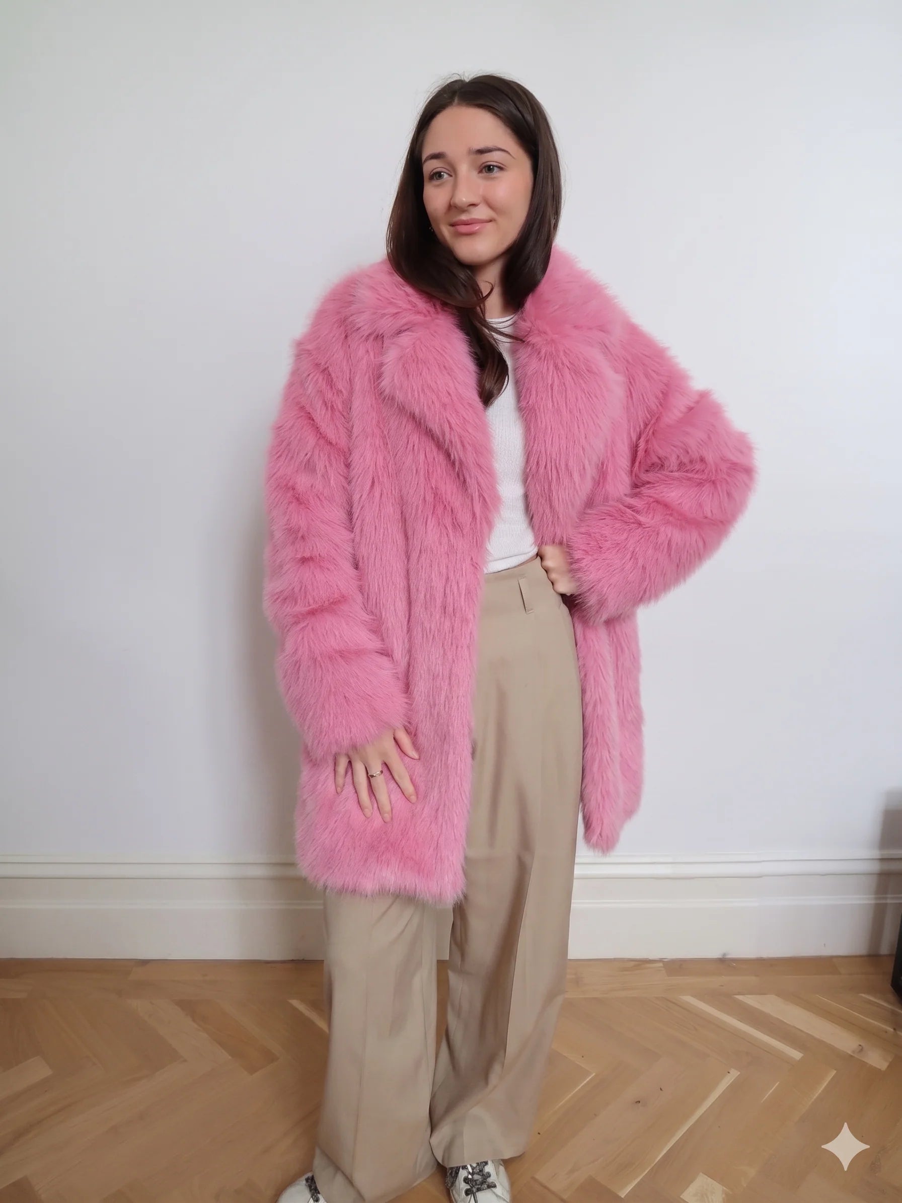 Pink faux fur long coat featuring a soft fluffy texture, classic collar, and two-button front closure.