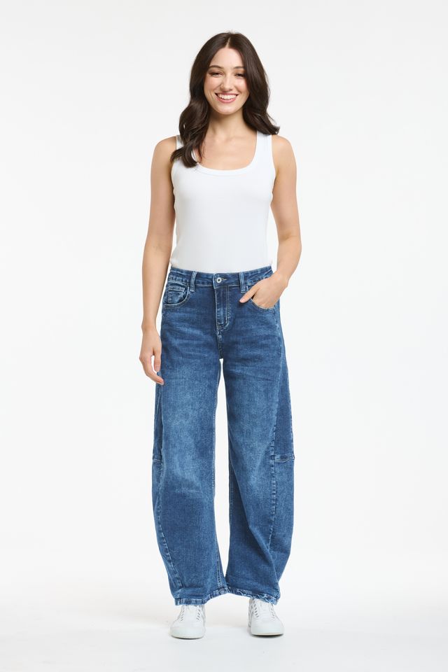 Blue denim barrel leg jeans with curved silhouette and tapered ankle