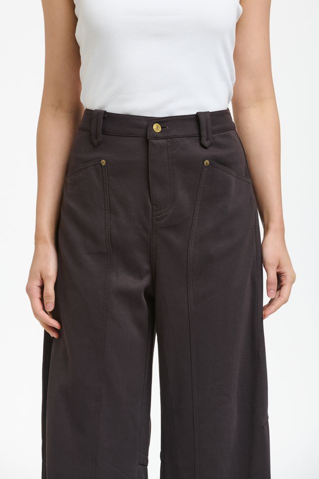 Italian Star PIMMS Pant in Morro, a rich chocolate plum shade, featuring a relaxed high-rise fit and on-trend wide-leg barrel silhouette. Made from a comfortable stretch cotton blend, these pants showcase a distinctive front pocket panel design, belt loops, zip fly, and cargo patch pockets at the back, creating a stylish yet casual aesthetic.