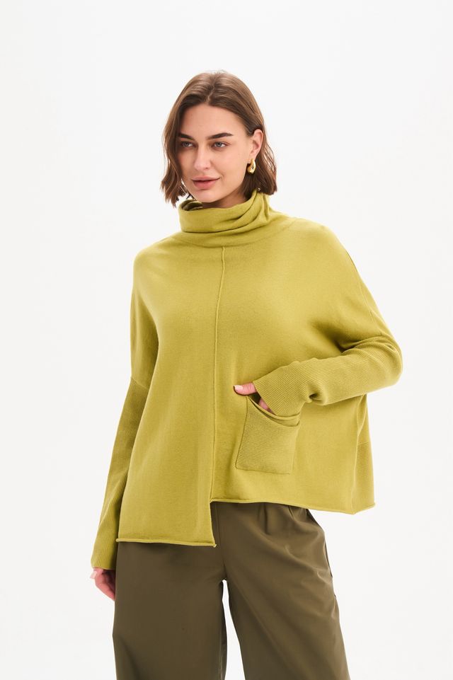 Tirelli Roll Hem Pocket Knit in Deep Citrus featuring a relaxed oversized fit, rolled cowl neckline, ribbed sleeves, front patch pocket, exposed centre seam, and asymmetrical roll hem in a vibrant citrus green knit.