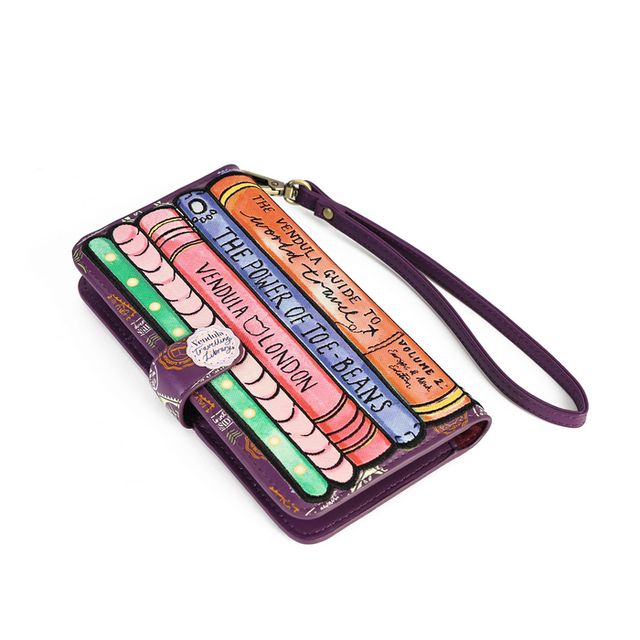 Vendula London The Travelling Library Bookshop Universal Flip Phone Case in printed and embossed vegan leather, featuring charming travelling library artwork and bookshop-inspired details. Designed with hand-stitched accents, magnetic snap closure, three card slots including an ID window, a slip pocket for notes or documents, a sliding camera track and an expandable grip to secure the phone.
