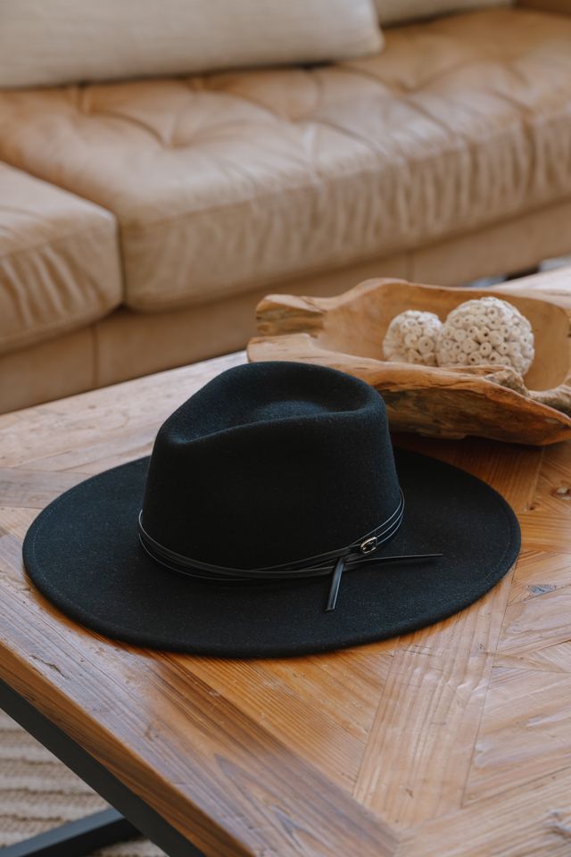 Black wool felt hat with soft structured crown and medium brim, classic neutral styling.