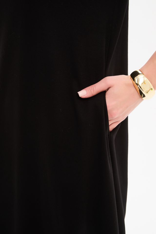 Black jersey midi dress featuring a round neckline, 3/4 sleeves, side pockets, relaxed cocoon silhouette, and banded hem.