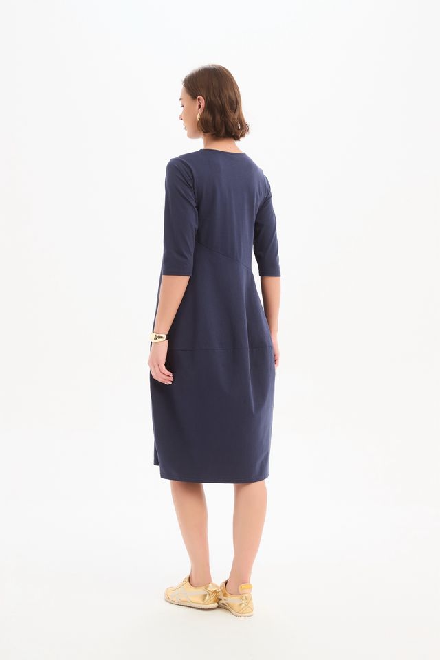 Tirelli Diagonal Seam Winter Dress in navy featuring a midi-length silhouette, diagonal seam detailing, rounded bubble hem, round neckline, and side pockets