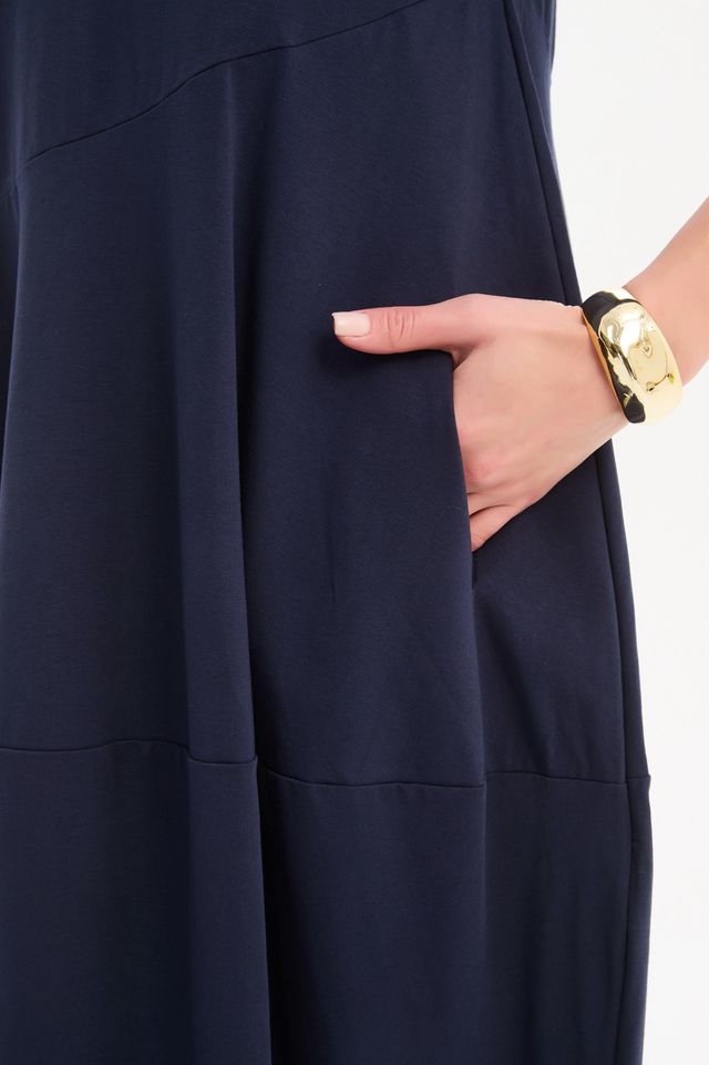 Tirelli Diagonal Seam Winter Dress in navy featuring a midi-length silhouette, diagonal seam detailing, rounded bubble hem, round neckline, and side pockets
