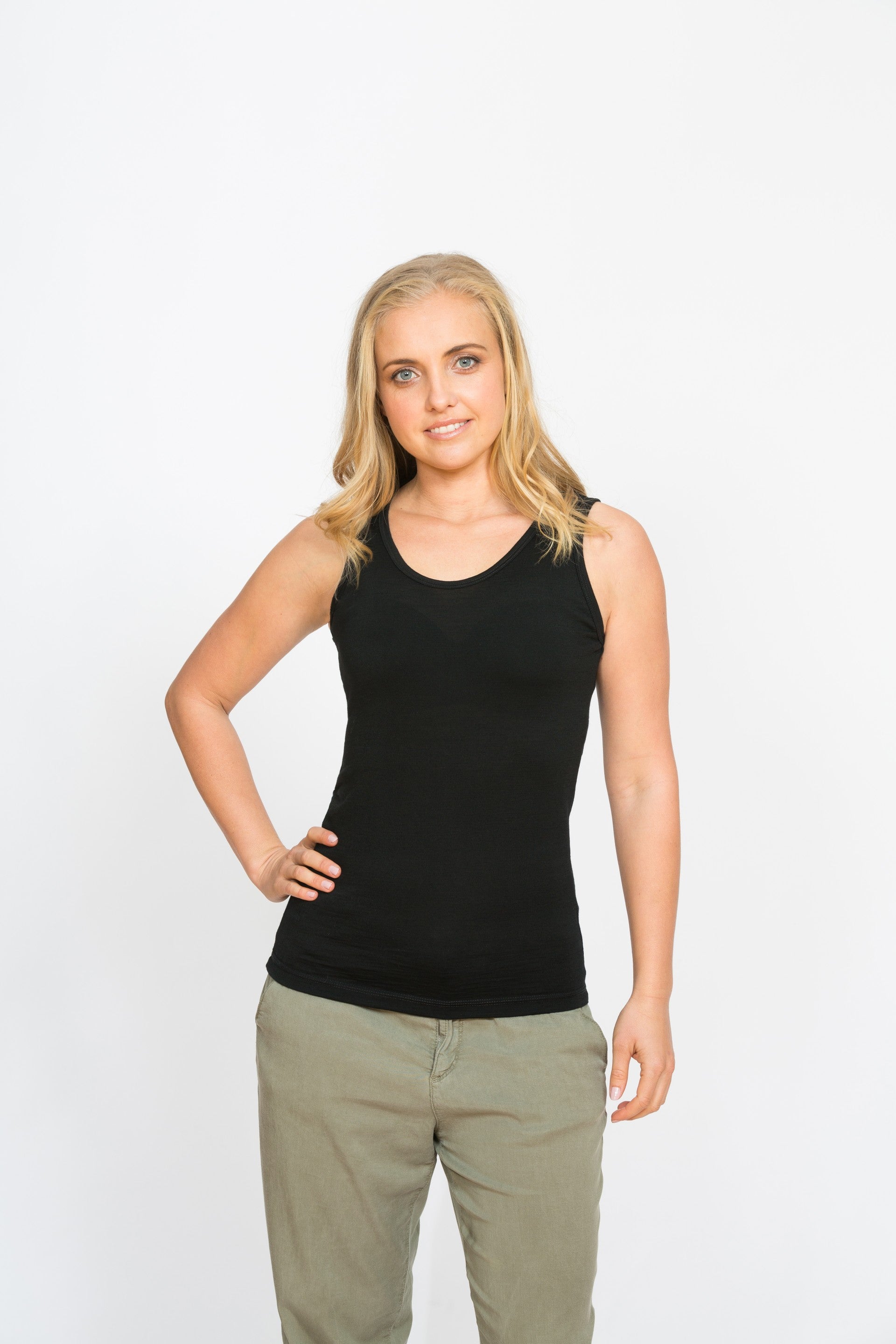 Black merino reversible singlet featuring V-neck and scoop neck design, soft jersey knit texture, and sleek lightweight fitted shape.