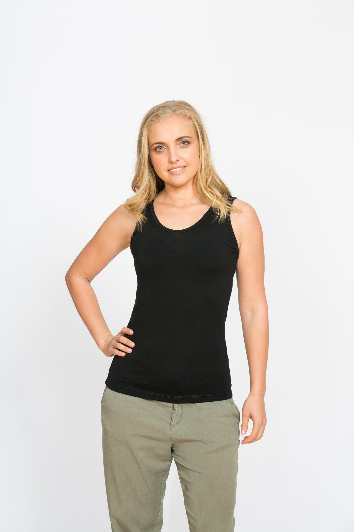 Black merino reversible singlet featuring V-neck and scoop neck design, soft jersey knit texture, and sleek lightweight fitted shape.