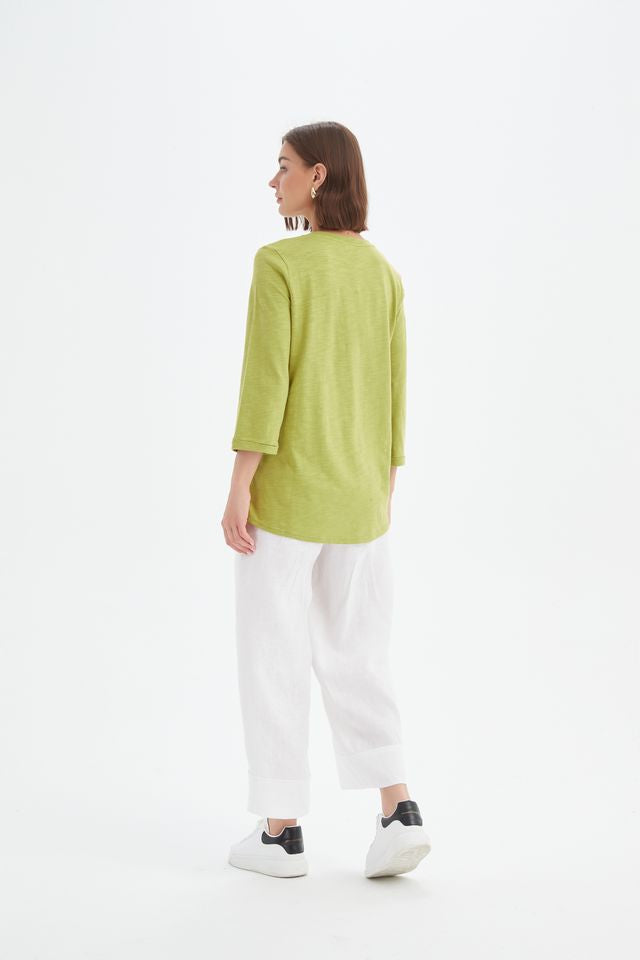 Chartreuse cotton slub tee featuring a round neckline with V-insert detail, 3/4 sleeves, relaxed fit, and curved hem.