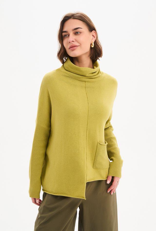 Tirelli Roll Hem Pocket Knit in Deep Citrus featuring a relaxed oversized fit, rolled cowl neckline, ribbed sleeves, front patch pocket, exposed centre seam, and asymmetrical roll hem in a vibrant citrus green knit.